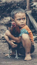 Portrait of boy sitting outdoors