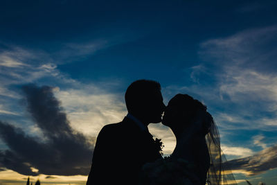 Silhouette couple against sky