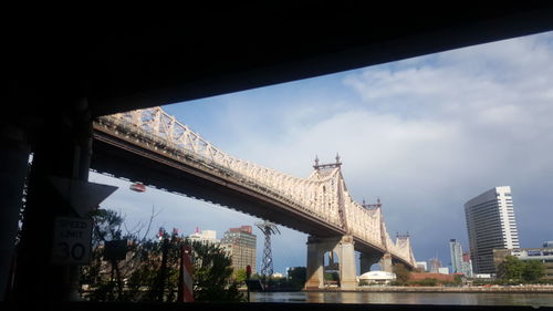 Low angle view of bridge against sky in city