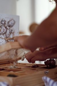 Cropped hand of man holding jigsaw pieces