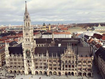 Aerial view of buildings in city against sky