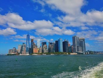 One world trade center by east river against sky in city