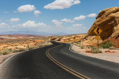 Road amidst mountains against sky