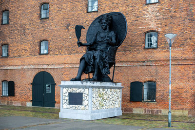 Low angle view of statue against building