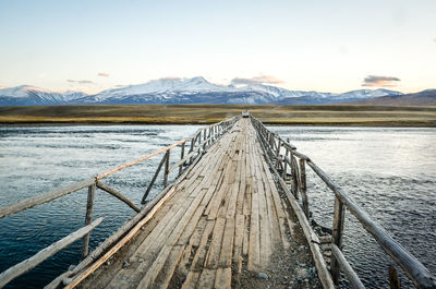 Pier over lake against sky