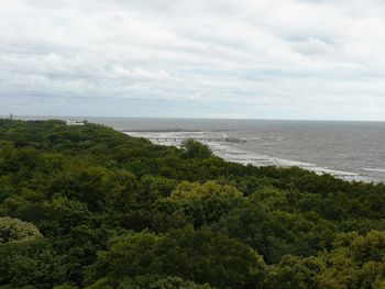 Scenic view of calm sea against cloudy sky