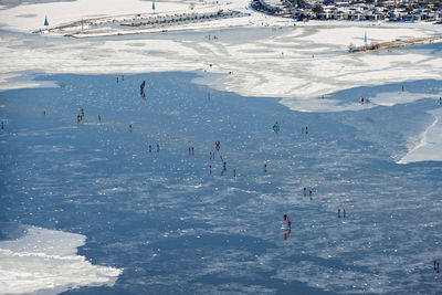 High angle view of people skiing on snow