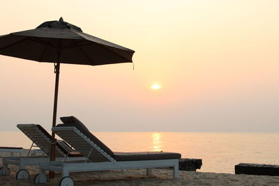 Built structure on beach against clear sky during sunset