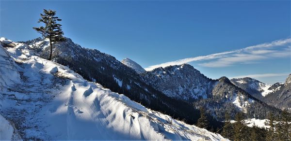 Scenic view of snow covered mountains against sky