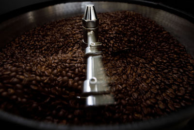 Brown coffee beans in roasting spin machine close up sport focus and long exposure shot
