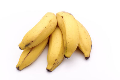 High angle view of yellow slices over white background