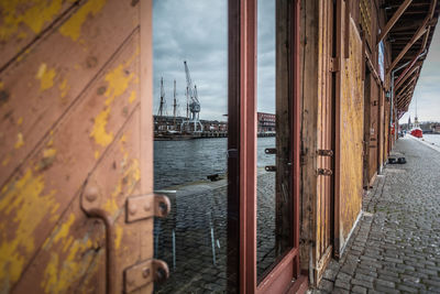 Sailboats in sea against buildings in city