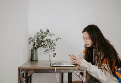 Portrait of young woman sitting at home