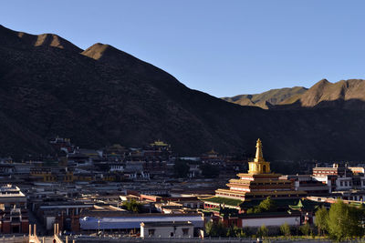 Buildings in city against clear sky