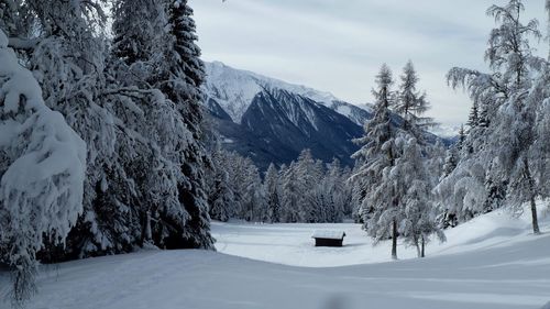 Scenic view of snow covered mountains against sky