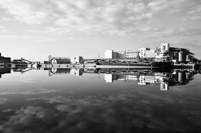 Reflection of building in lake against sky