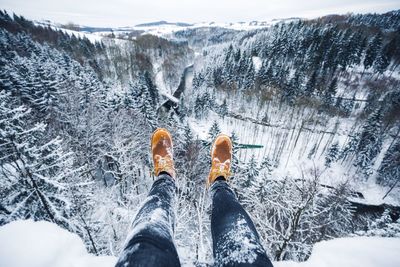 Low section of tourist on snow covered mountain