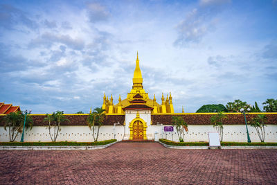 Low angle view of temple against cloudy sky