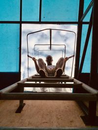 Low section of woman sitting on chair