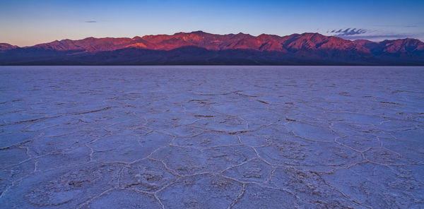 Scenic view of desert against sky during winter