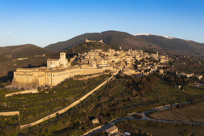 Panoramic linear aerial view of the city of assisi umbria with mount subasio