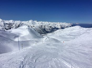 Scenic view of snowcapped mountains against clear sky