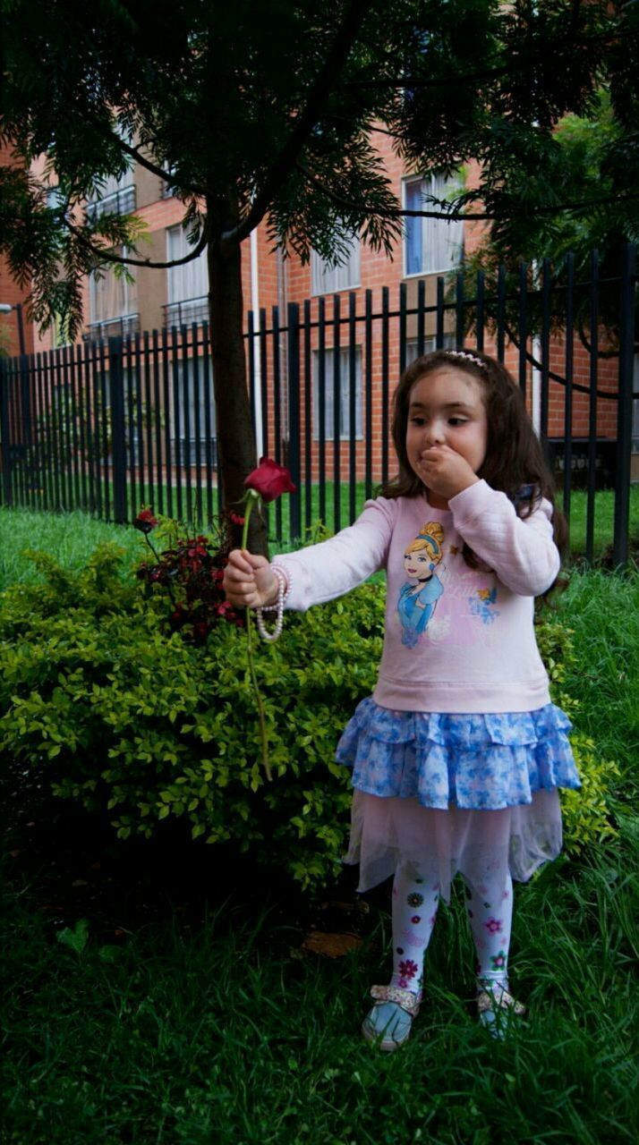 PORTRAIT OF SMILING GIRL PLAYING IN PARK