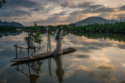 Scenic view of lake against sky during sunset