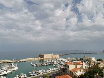 High angle view of harbor by buildings against sky