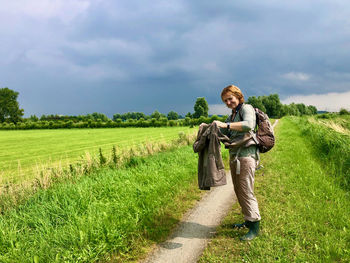 Man standing on field against sky