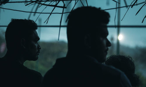 Portrait of silhouette friends against sky at dusk