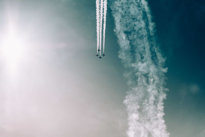 Low angle view of airplane flying against sky