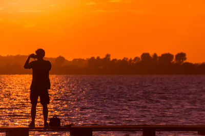 Silhouette of people at sunset