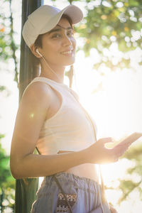 Side view of young woman standing outdoors