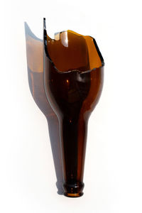 Close-up of beer in glass against white background