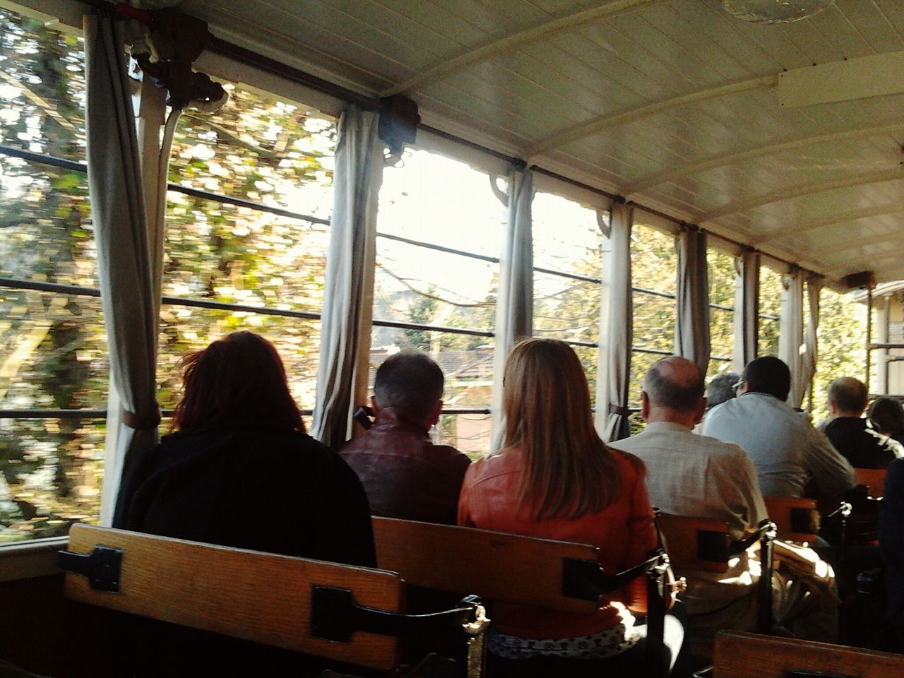 indoors, people, sitting, window, lifestyles, chair, leisure activity, glass - material, table, rear view, interior, restaurant, standing, medium group of people, togetherness, relaxation