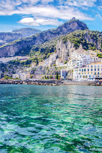 Scenic view of sea and buildings in city