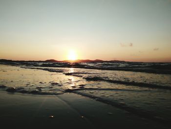 Scenic view of sea against clear sky during sunset