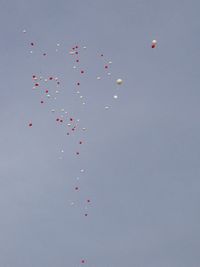 Low angle view of red balloons