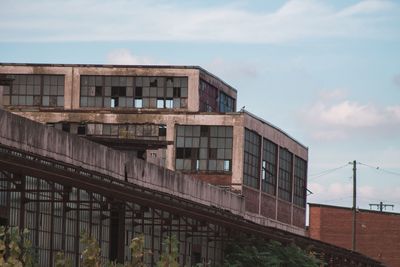 Low angle view of abandoned building against sky