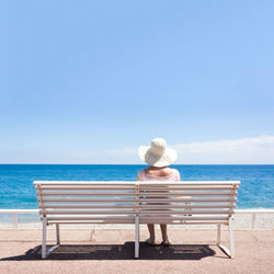 Rear view of man looking at sea against sky