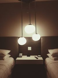 Close-up of illuminated electric lamp on sofa at home