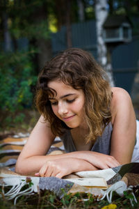 Portrait of young woman sitting on field