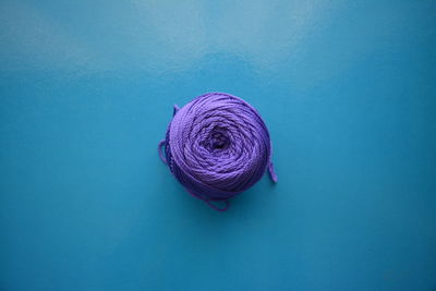Purple ball of yarn on a blue table