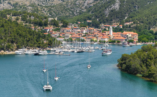 Tourist ships and sailing boats in marina in old town of skradin in croatia