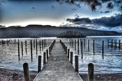 Pier over lake against sky