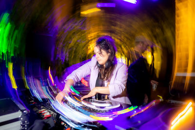 Side view of woman looking through window