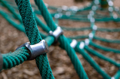 Cropped image of green rope equipment in playground