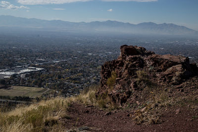 Aerial view of land and mountains against sky