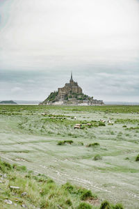 Church on field against sky